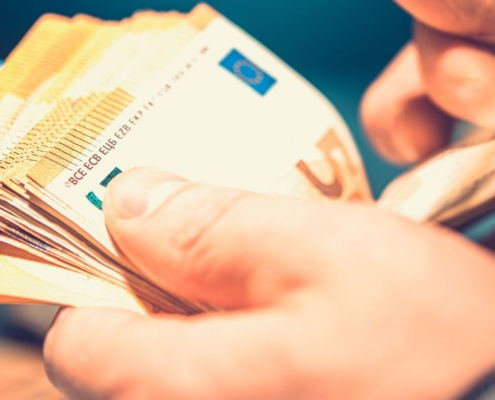 Male hands counting a bunch of Euro notes