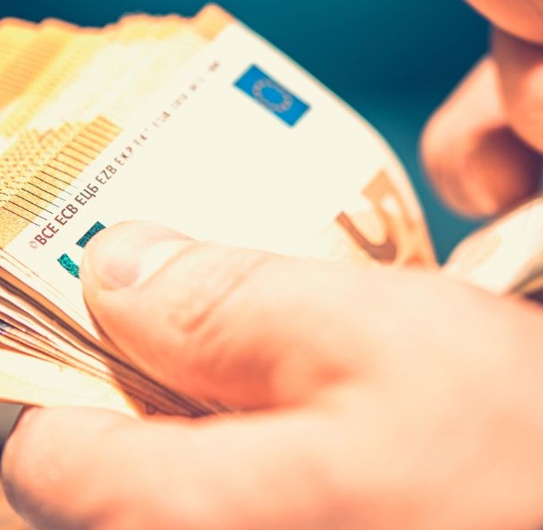 Male hands counting a bunch of Euro notes