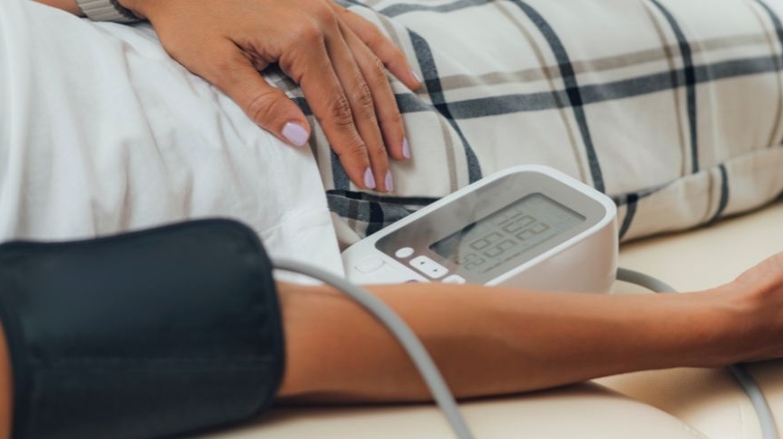 Person laying down having their blood pressure measured